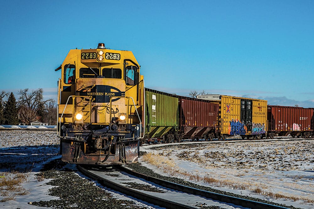 A Northern Plains Railroad train on a track during the winter.