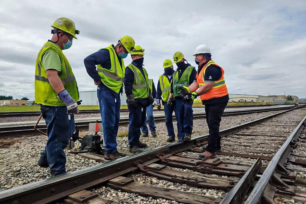 A group of Northern Plains Railroad employees listening to a training session from a supervisor