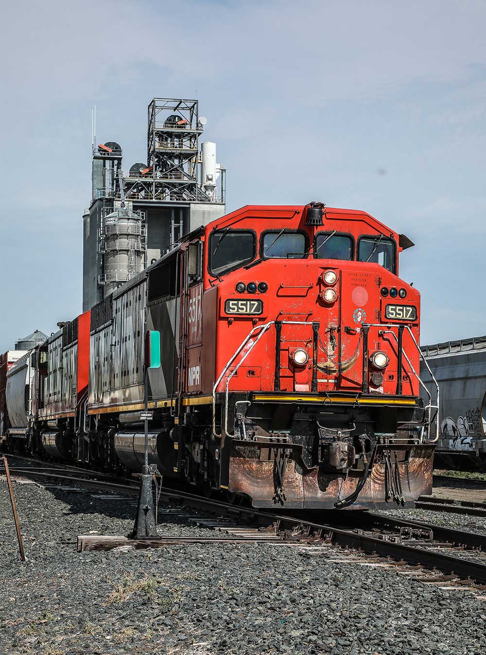 A bright red Northern Plains Railroad train engine on a track.