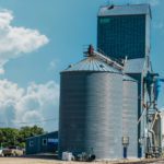 A CHS grain elevator next to a railroad in a small midwestern town.