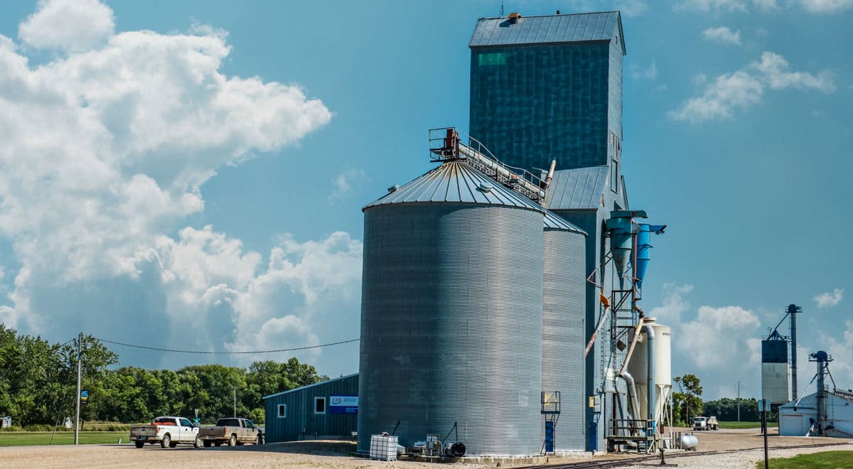 A CHS grain elevator next to a railroad in a small midwestern town.