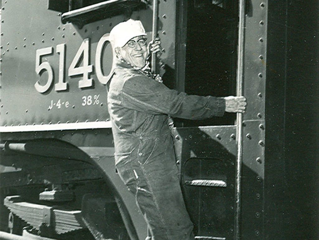 A black and white photo taken in 1955 of W.R. Bailey, a past steam locomotive engineer for Northern Plains Railroad Services.