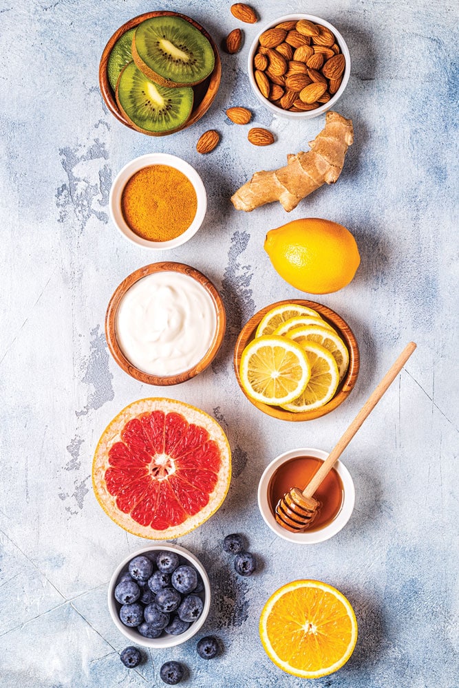 Healthy foods arranged in two vertically oriented rows on a concrete slab.