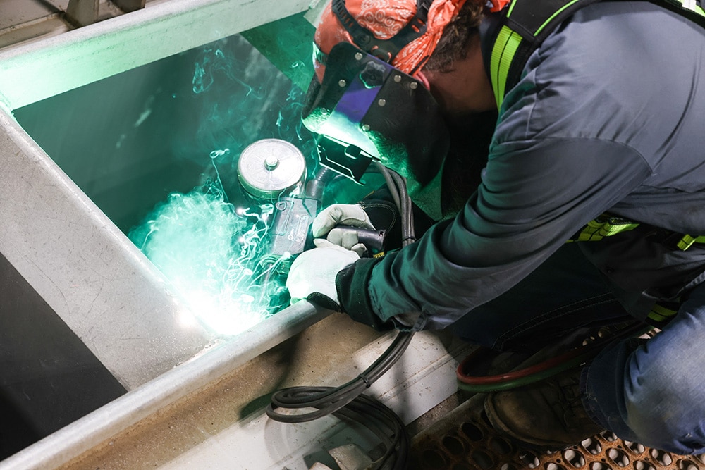 Northern Plains Railroad Service worker welding on a train car