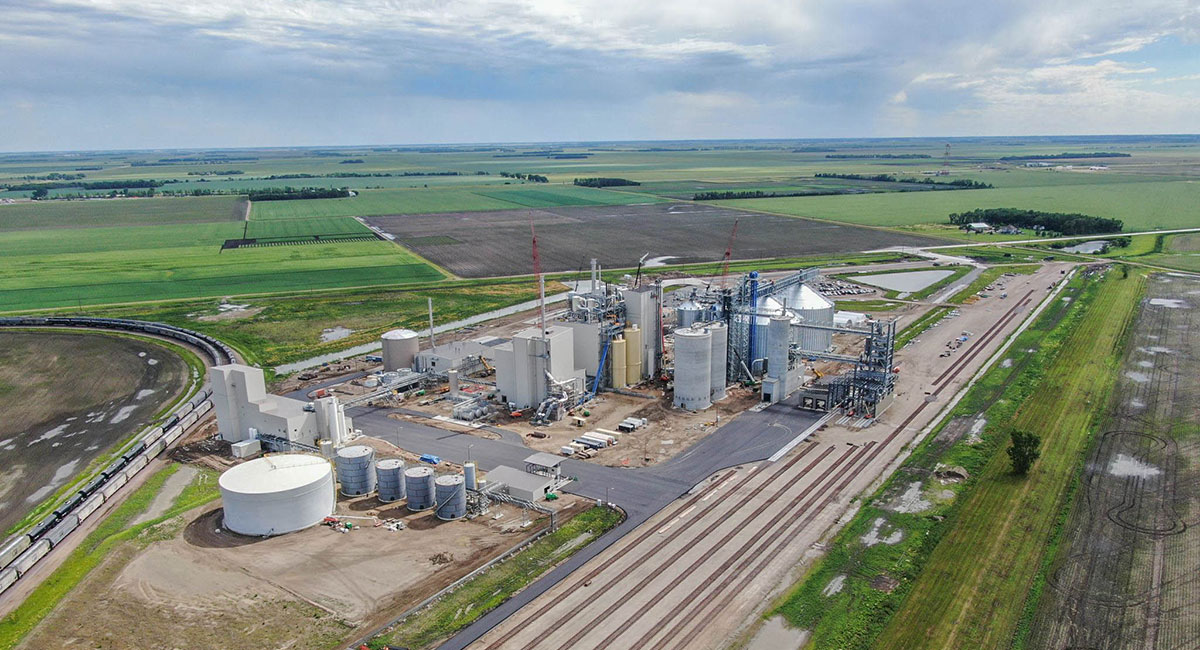 Aerial view of an agricultural plant near a railroad track.