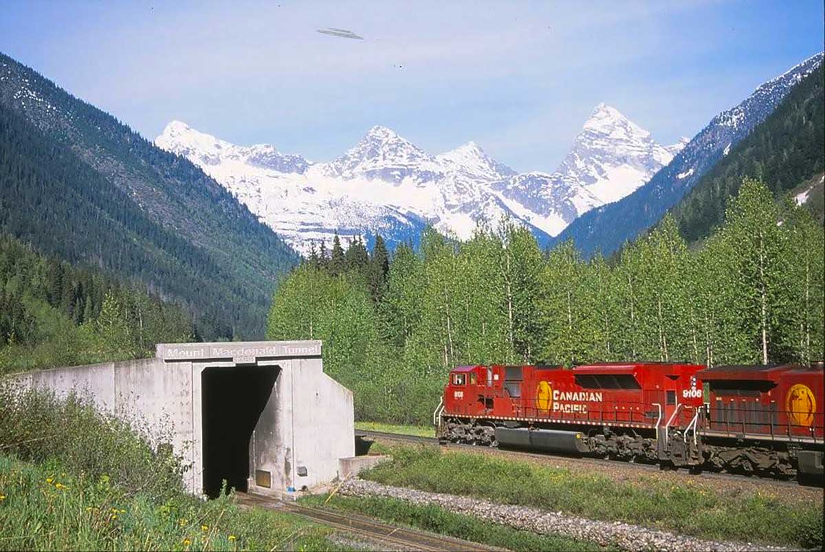 A master engineering achievement—CPKC's’s Mount Macdonald Tunnel, while an eastbound train passes on the Connaught Tunnel line.