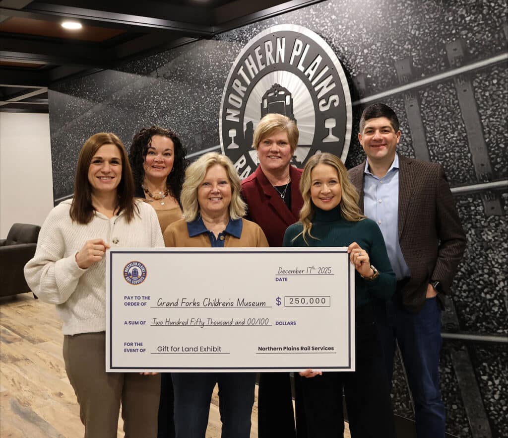 NPRS employees holding a check with their $250,000 pledge to the Grand Forks Children’s Museum.